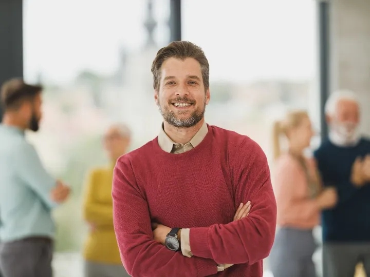 Man in a red sweater in an office