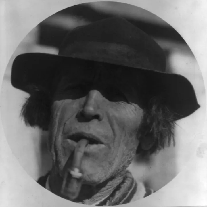 Faded old portrait of a man in a hat